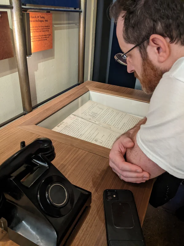 Author viewing Turing's notes on the Bombe computer